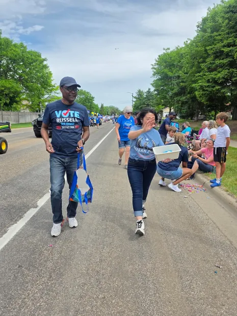 Wynfred Russell walking in a neighborhood parade